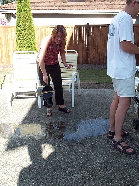 Susan watering the concrete